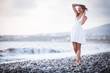 Young woman on the beach enjoying a warm summer evening