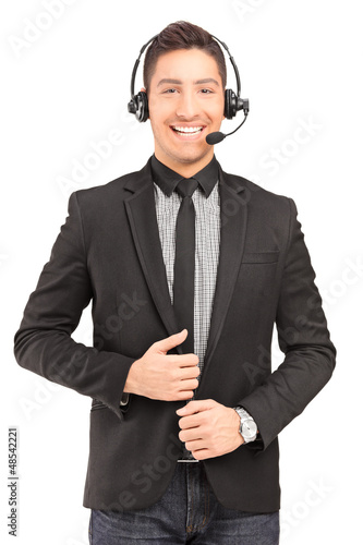 Photo: A handsome male customer service operator wearing a headphones a A handsome male customer service operator wearing a headphones a