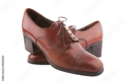 Photo: Vintage female shoes isolated on white Vintage female shoes isolated on white