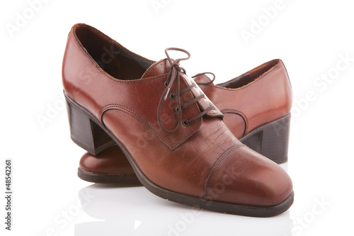 Photo: Vintage female shoes isolated on white Vintage female shoes isolated on white