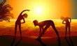 Silhouettes of a woman doing sport exercises on the beach