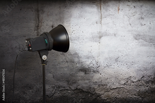 Photo: spot light on concrete wall spot light on concrete wall