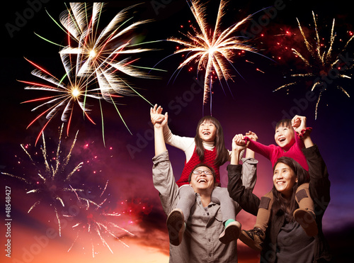 Photo: happy asian family looking fireworks happy asian family looking fireworks