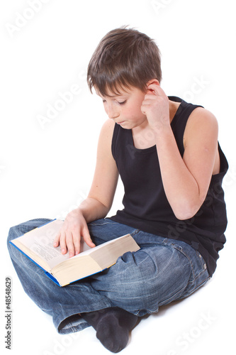 Photo: boy reading a book boy reading a book