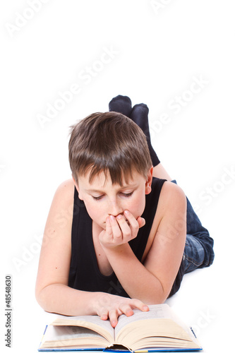 Photo: boy reading a book boy reading a book