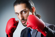 Businessman with boxing gloves on white