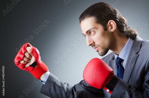 Photo: Businessman with boxing gloves on white Businessman with boxing gloves on white