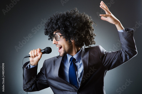 Photo: Man with afro haircut singing in studio Man with afro haircut singing in studio