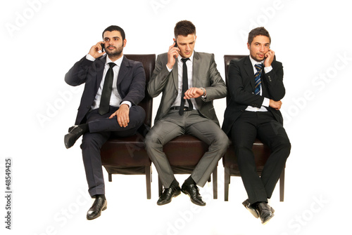 Photo: Business men talking by phones Business men talking by phones