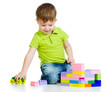 Photo: kid boy playing with construction set over white background kid boy playing with construction set over white background