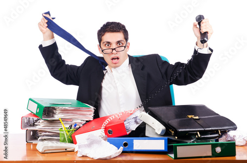 Photo: Young busy businessman at his desk Young busy businessman at his desk