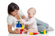 baby girl and mother playing together with construction set toy