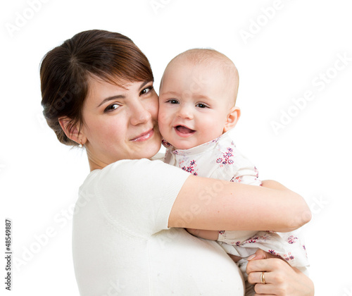 Photo: Happy mother embracing her daughter child isolated Happy mother embracing her daughter child isolated