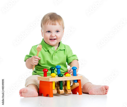 Photo: child playing toy isolated on white background child playing toy isolated on white background