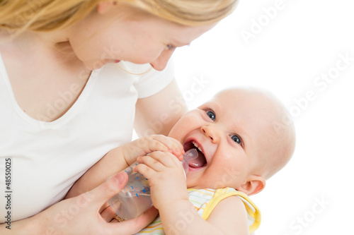 Photo: mother feeding from bottle her adorable baby boy mother feeding from bottle her adorable baby boy