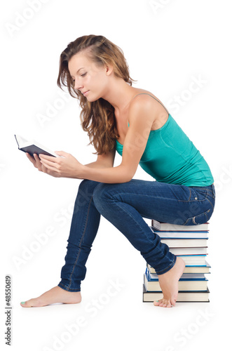Photo: Student sitting on stack of books Student sitting on stack of books