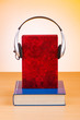 Concept of audio books with earphones on white
