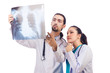 Two doctors looking at x-ray image on white