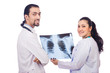 Two doctors looking at x-ray image on white