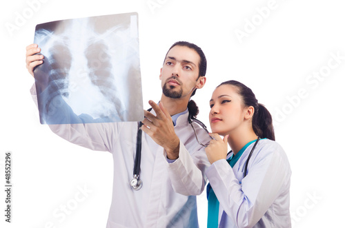 Photo: Two doctors looking at x-ray image on white Two doctors looking at x-ray image on white