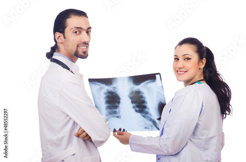 Photo: Two doctors looking at x-ray image on white Two doctors looking at x-ray image on white