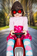 Girl on toy racing car