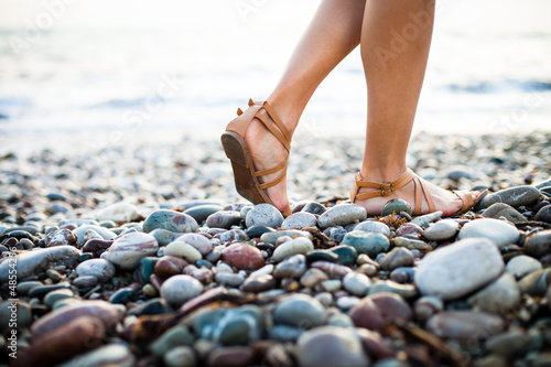 Photo: Young woman on the beach enjoying a warm summer evening Young woman on the beach enjoying a warm summer evening