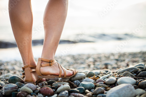 Photo: Young woman on the beach enjoying a warm summer evening Young woman on the beach enjoying a warm summer evening
