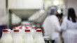 lots of bottles with fresh milk pack in plastic packaging