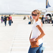 Departure - young woman at an airport about to board an aircraft