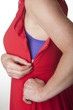 Woman pulling the zip up or down on her red dress