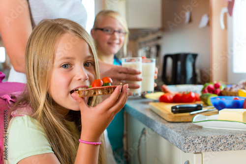 Photo: Family - mother making breakfast for school Family - mother making breakfast for school