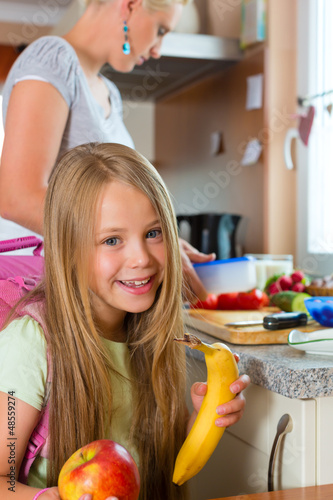 Photo: Family - mother making breakfast for school Family - mother making breakfast for school