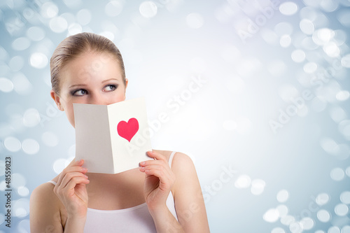 Photo: beautiful young woman holding a valentine postcard beautiful young woman holding a valentine postcard