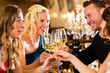Friends in a very good restaurant clink glasses