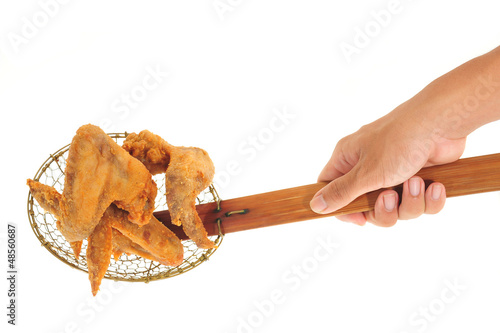 Photo: Scooping Up Fried Chicken Wings With A Kitchen Strainer Scooping Up Fried Chicken Wings With A Kitchen Strainer