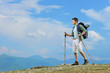 A young hiker with backpack hiking a mountain