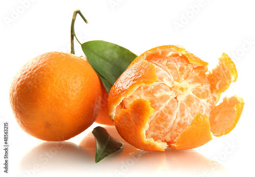 Photo: Ripe sweet tangerines with leaves, isolated on white Ripe sweet tangerines with leaves, isolated on white
