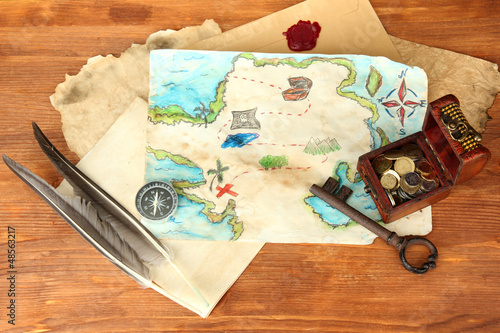 Photo: map of treasures on wooden background map of treasures on wooden background