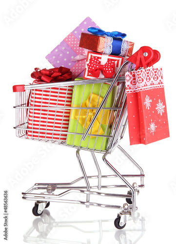 Photo: Christmas gifts and shopping in trolley isolated on white Christmas gifts and shopping in trolley isolated on white
