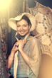 woman in old hat with a lace umbrella