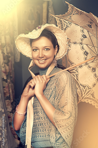 Photo: woman in old hat with a lace umbrella woman in old hat with a lace umbrella