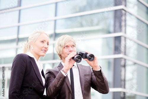 Photo: business people pointing binoculars business people pointing binoculars