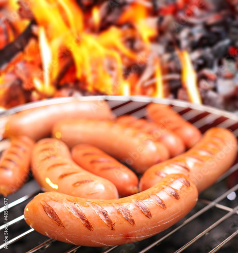Photo: Sausages on a grill. Sausages on a grill.