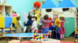 toy on table, in defocus clown blow bubbles for children