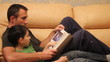 father and son reading a book