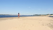 tanned young woman running on the beach