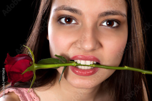Photo: Red rose in her mouth Red rose in her mouth