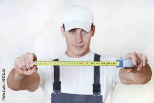 Photo: Handyman with measuring tape Handyman with measuring tape