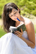 Foto: Pretty girl reading and writing in her diary Pretty girl reading and writing in her diary